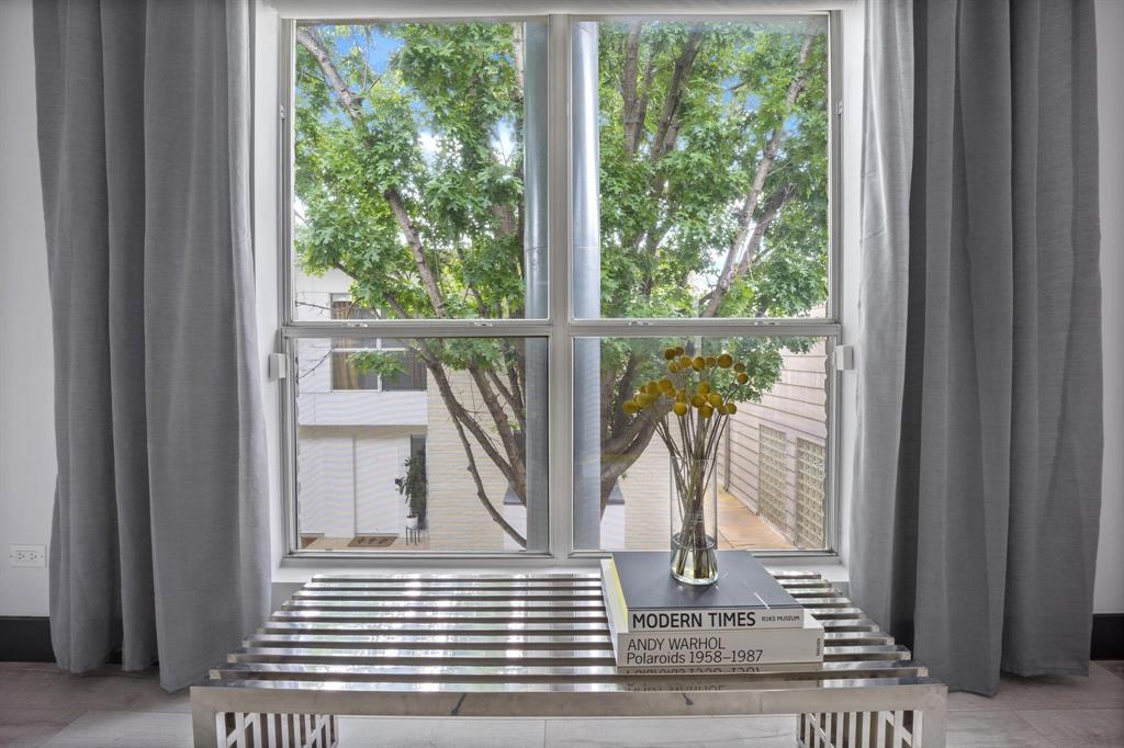 4134 Travis Street, Unit 11 Dallas, TX 75204 - Photo 21 of 29 a view of a balcony with wooden floor and a potted plant