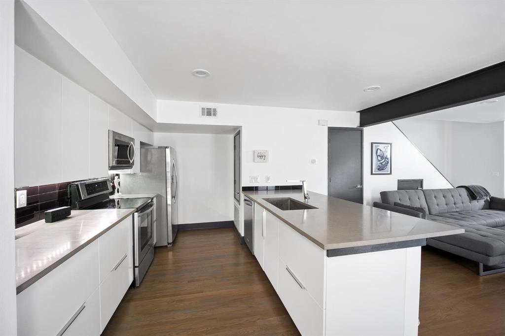 4134 Travis Street, Unit 11 Dallas, TX 75204 - Photo 7 of 29 a kitchen with stainless steel appliances granite countertop a sink and a stove