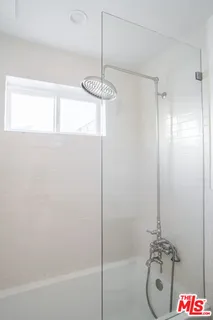 a bathroom with a shower and a sink