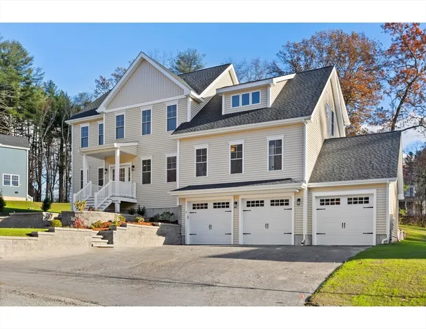 a large kitchen with kitchen island a sink appliances wooden floor and a view of living room