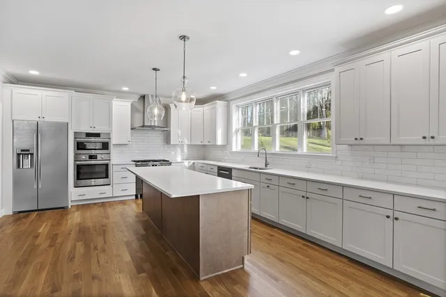 a view of a a dining room with furniture window and wooden floor