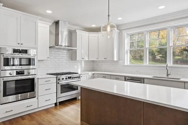 a spacious bathroom with a double vanity sink a mirror and a bathtub