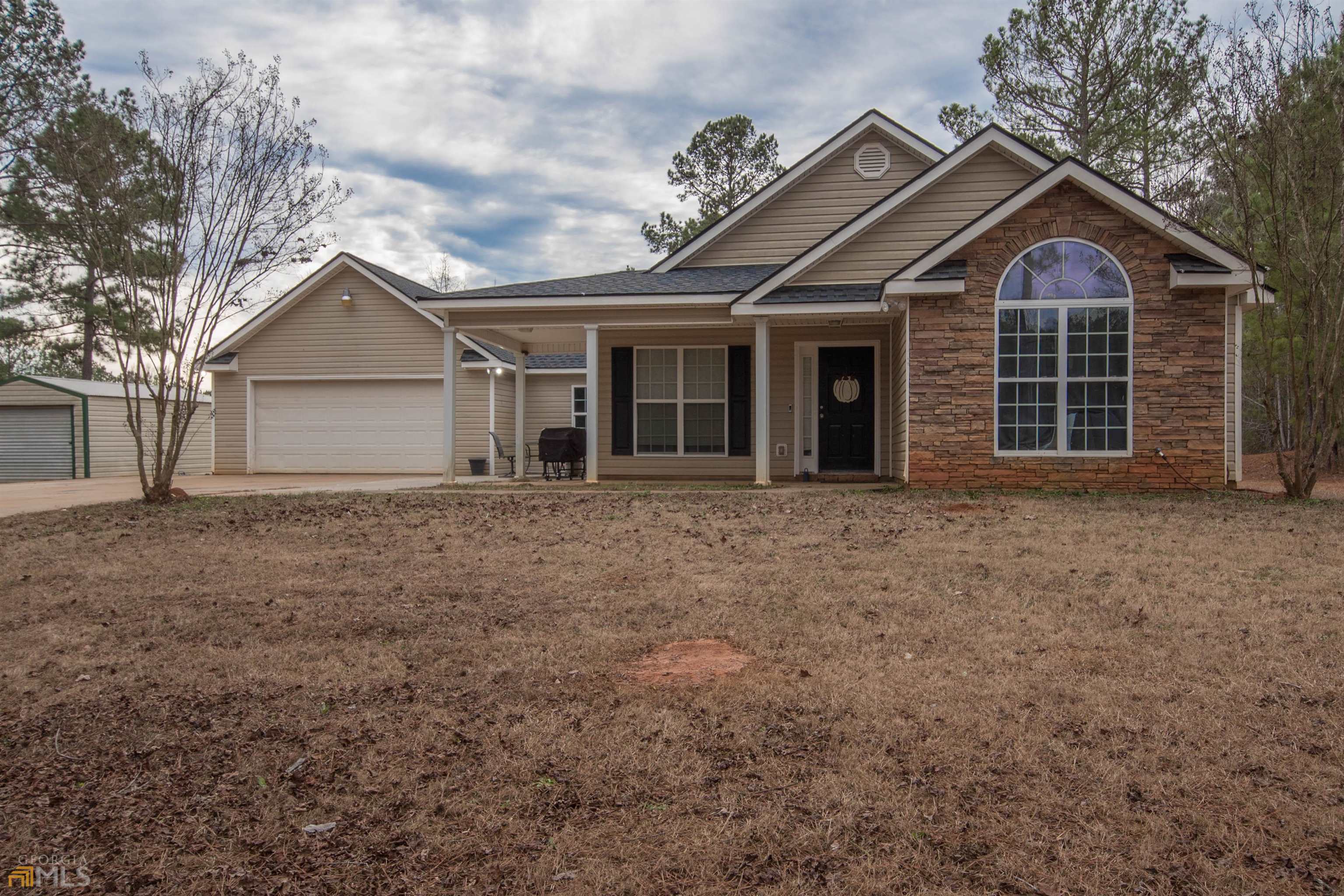 a front view of a house with a garden