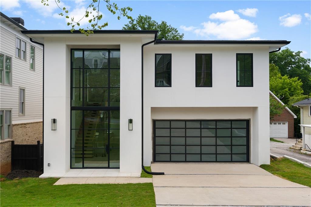 2931 Lookout Place Northeast Atlanta, GA 30305 - Photo 1 of 1 a front view of a house with a garage