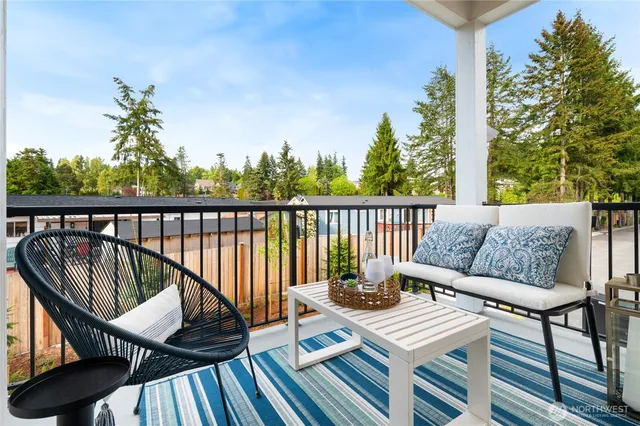 a view of a balcony with couches and wooden floor