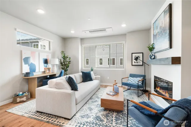 a living room with furniture fireplace and a window