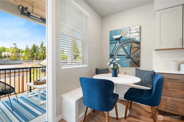 a dining room with furniture a rug and wooden floor