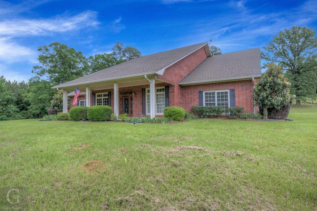 1212 WPA Road Homer, LA 71040 - Photo 5 of 35 Single story home with a front lawn, brick siding, a shingled roof, and covered porch