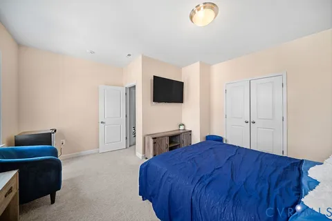 a bedroom with a bed and a flat screen tv