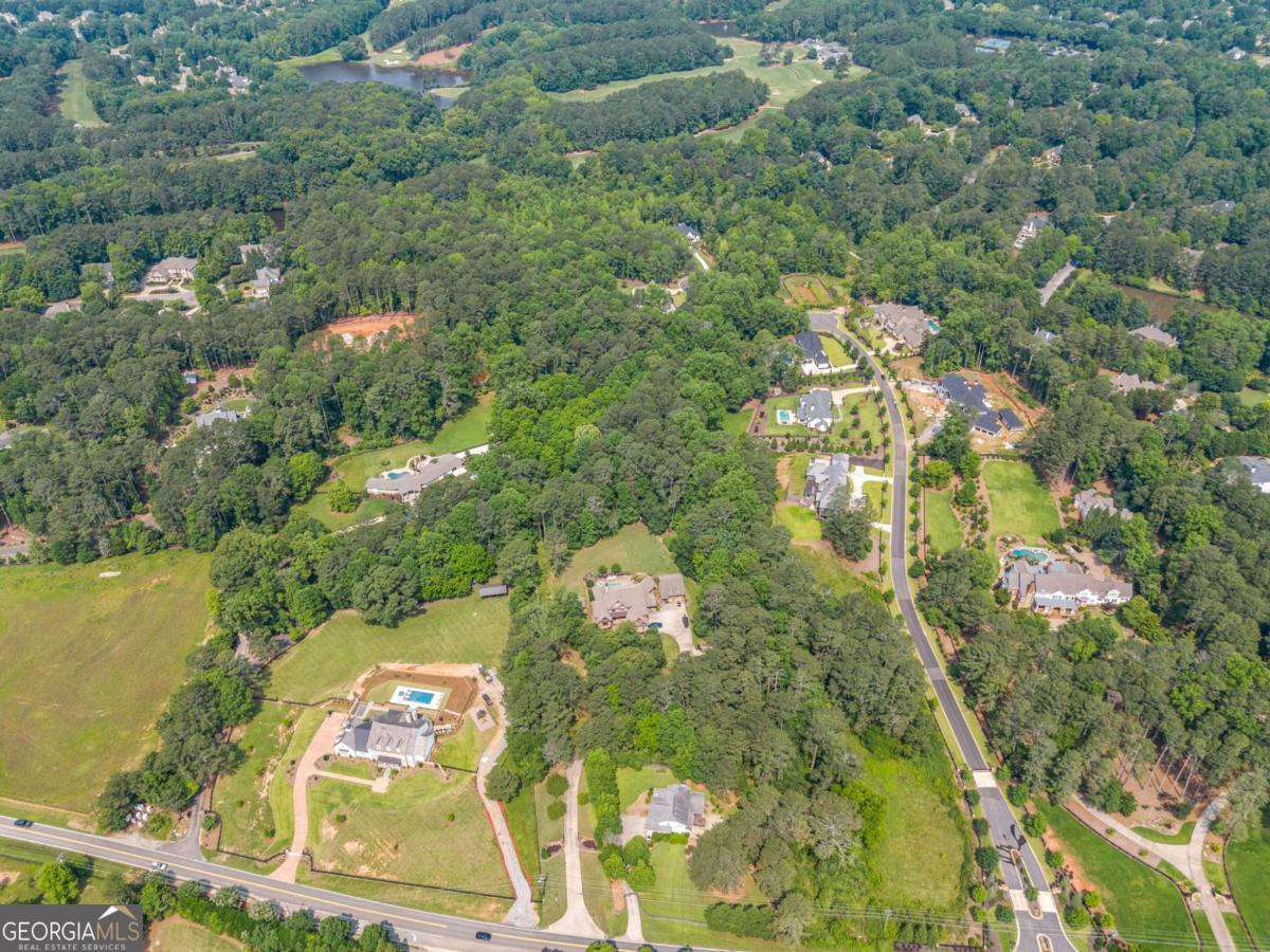 235 Brock Trail, Unit 3 Milton, GA 30004 - Photo 29 of 31 an aerial view of residential houses with outdoor space and trees