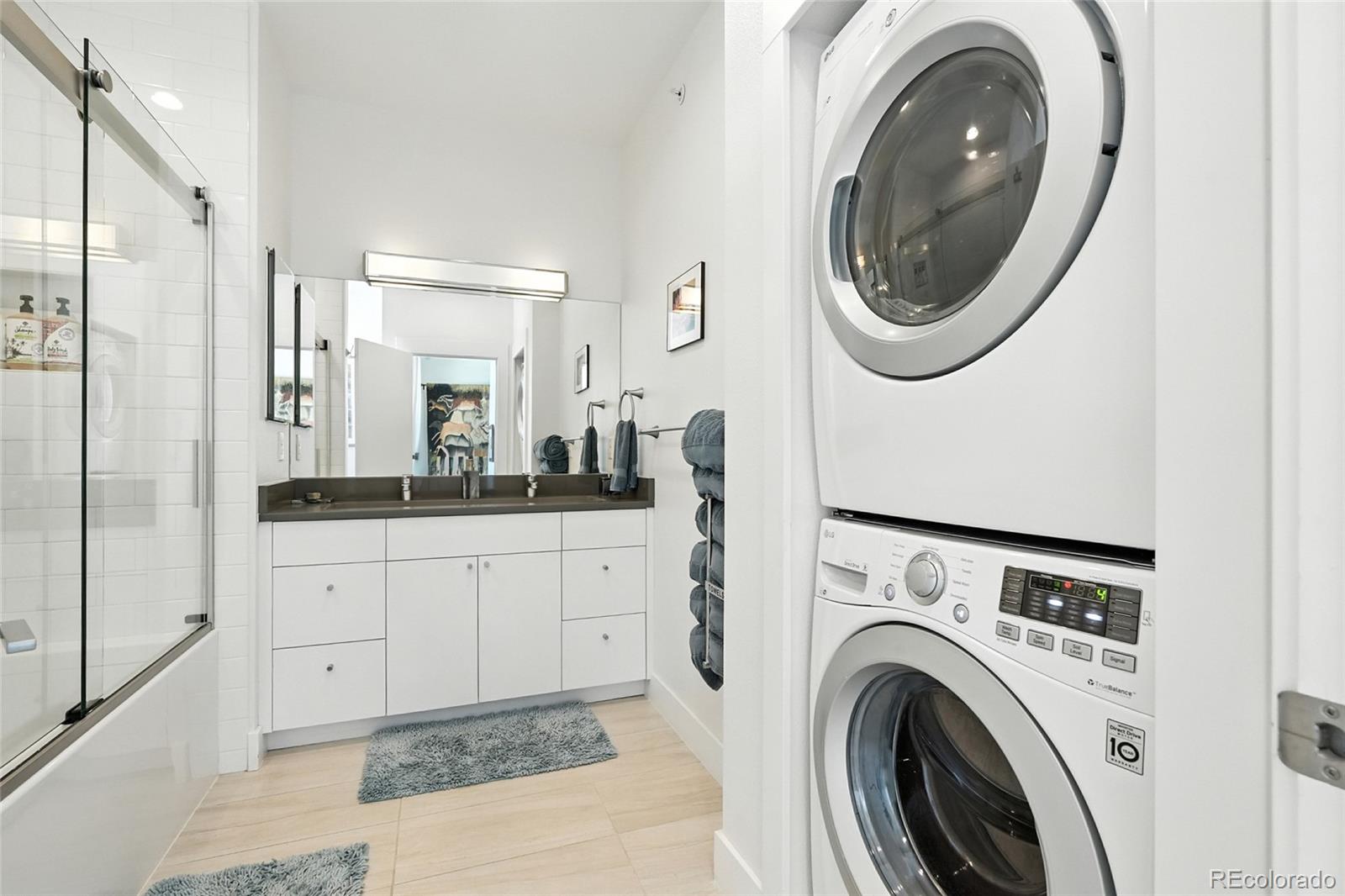 2530 28th Street, Unit 118 Boulder, CO 80301 - Photo 16 of 30 a spacious bathroom with a sink and a washer dryer