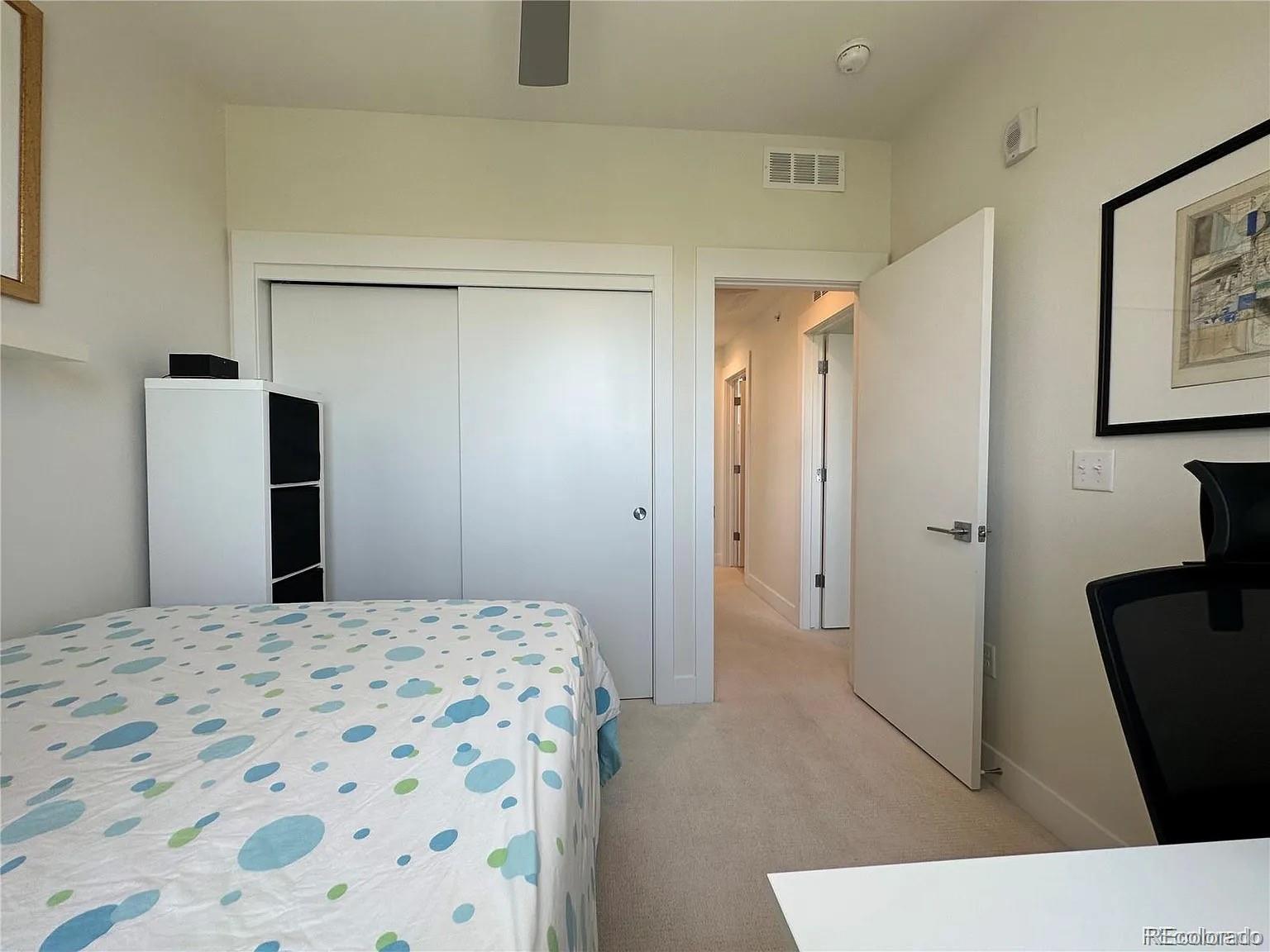 2530 28th Street, Unit 118 Boulder, CO 80301 - Photo 19 of 30 a bedroom with a bed and a mirror