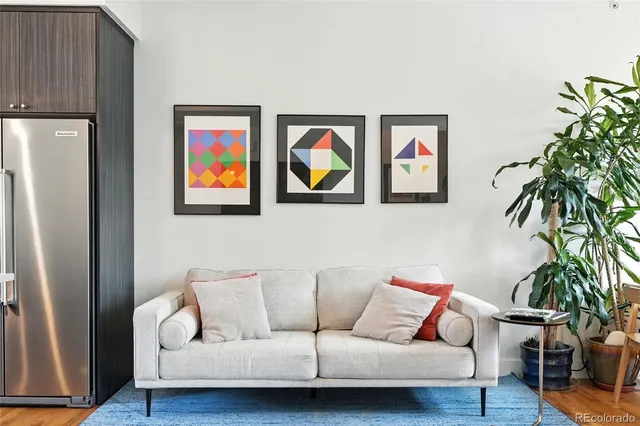a living room with furniture and a potted plant