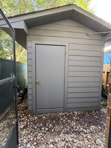 a view of a porch with a table and chairs