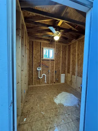 a bathroom with a granite countertop sink and shower
