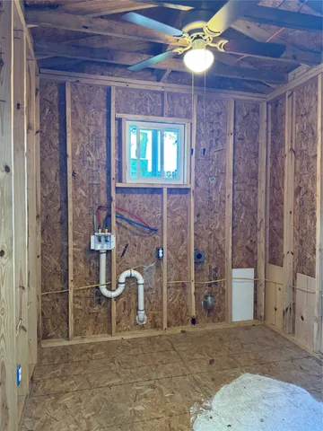 a view of a wooden door and a bench in the background