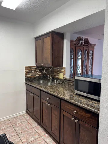 a kitchen that has a sink and a stove