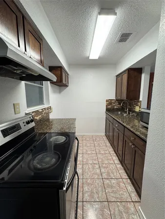 a kitchen with a refrigerator and stove