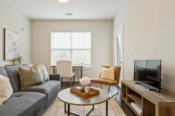 a living room with furniture and a flat screen tv