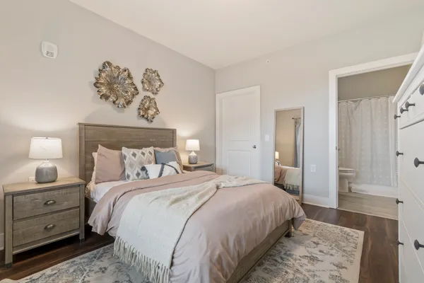 a bedroom with a bed and a painting on the wall