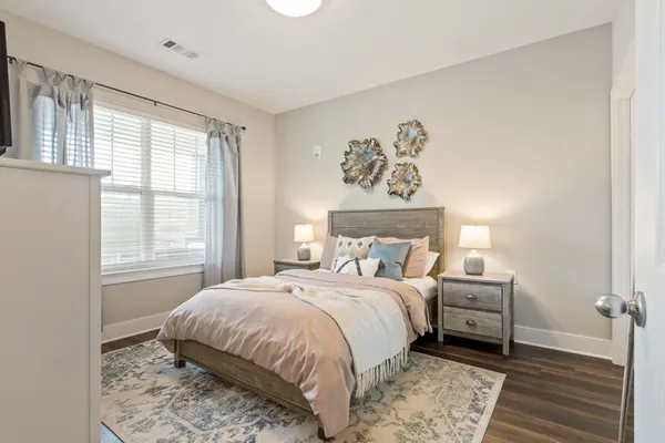 a bedroom with a bed and a window