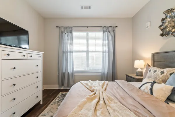 a bedroom with a bed and flat screen tv