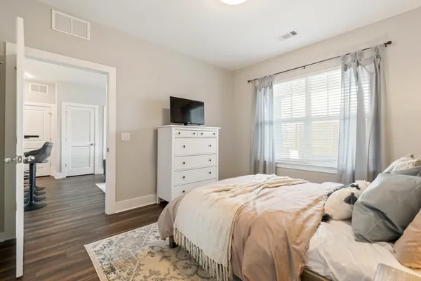 a bedroom with a bed and a flat screen tv