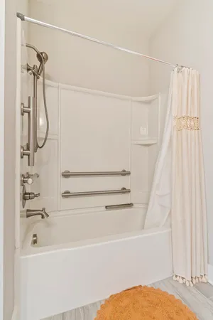 a bathroom with a bath tub with a shower