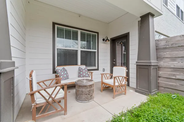 a view of a patio with couple of chairs