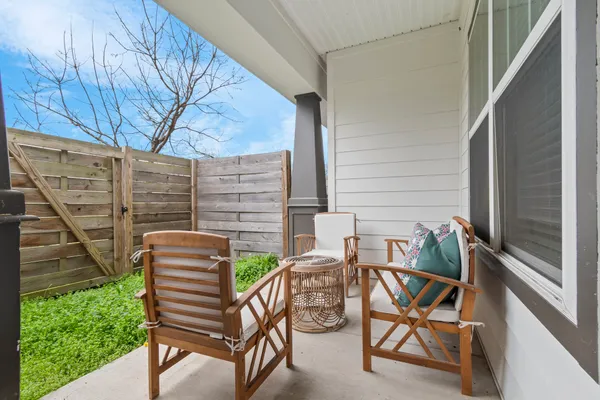 a view of balcony with two chairs and a potted plant