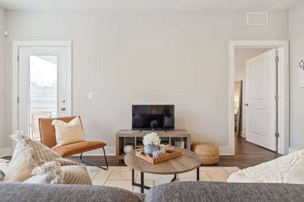 a living room with furniture and a flat screen tv