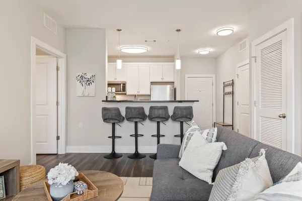 a living room with furniture and wooden floor