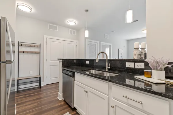 a kitchen with stainless steel appliances granite countertop a sink and cabinets