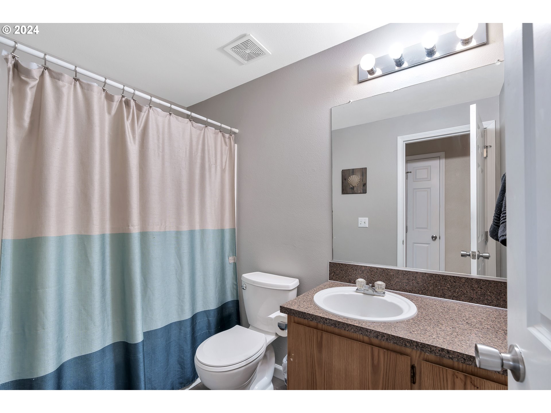 325 Cosmo Street Lafayette, OR 97127 - Photo 18 of 29 a bathroom with a granite countertop sink and a mirror