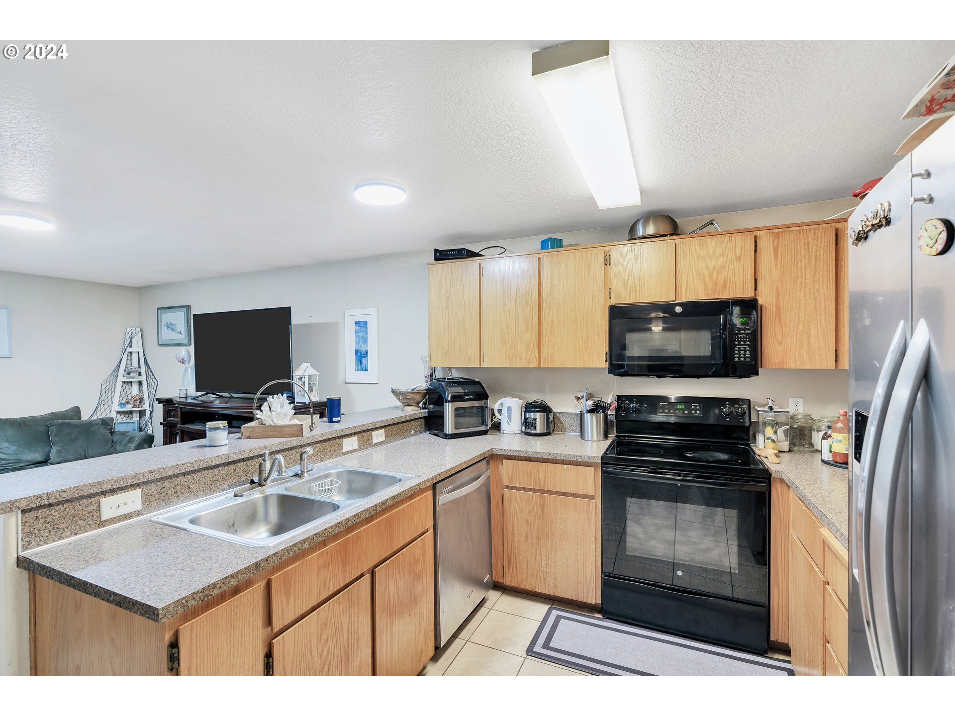 325 Cosmo Street Lafayette, OR 97127 - Photo 10 of 29 a kitchen with stainless steel appliances a stove sink microwave and refrigerator