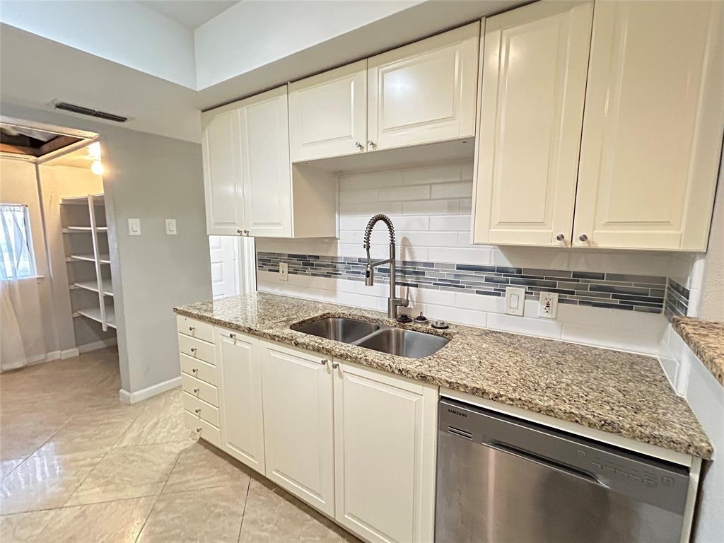 4535 North O'Connor Road, Unit 1216 Irving, TX 75062 - Photo 1 of 24 a kitchen with granite countertop a sink a stove and cabinets