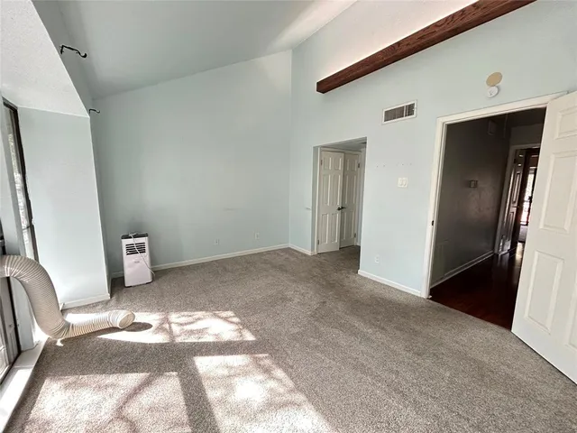 a view of a bedroom with wooden floor and furniture