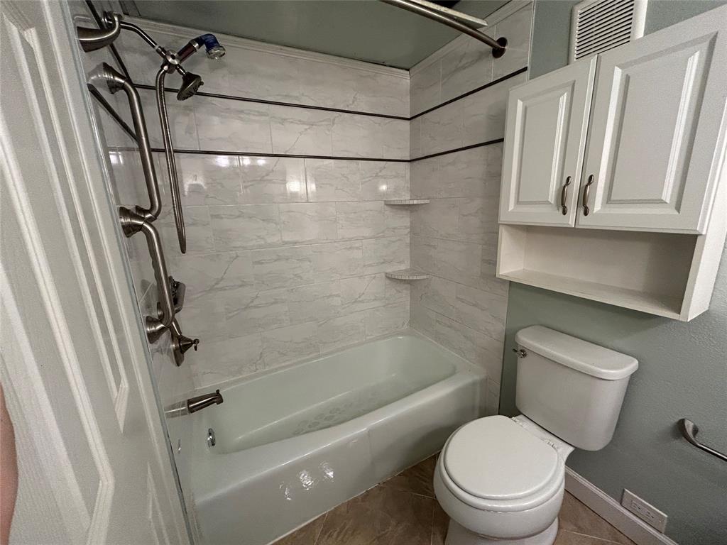 4535 North O'Connor Road, Unit 1216 Irving, TX 75062 - Photo 23 of 24 a bathroom with a shower a toilet and sink