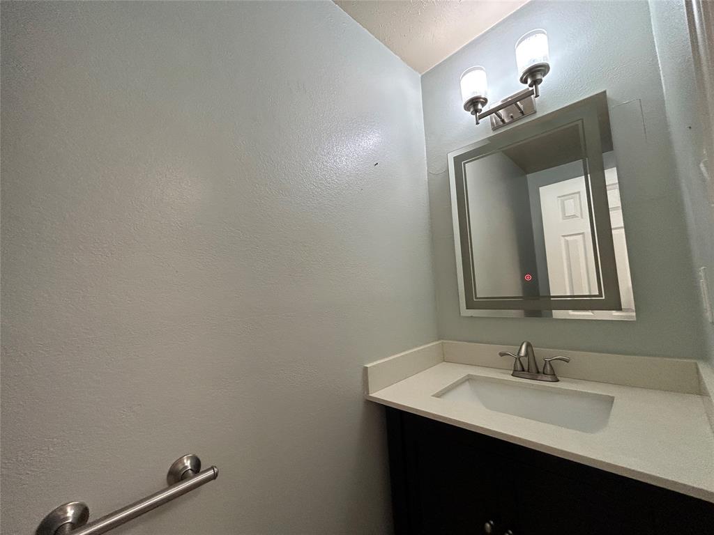 4535 North O'Connor Road, Unit 1216 Irving, TX 75062 - Photo 10 of 24 a bathroom with a sink and a mirror