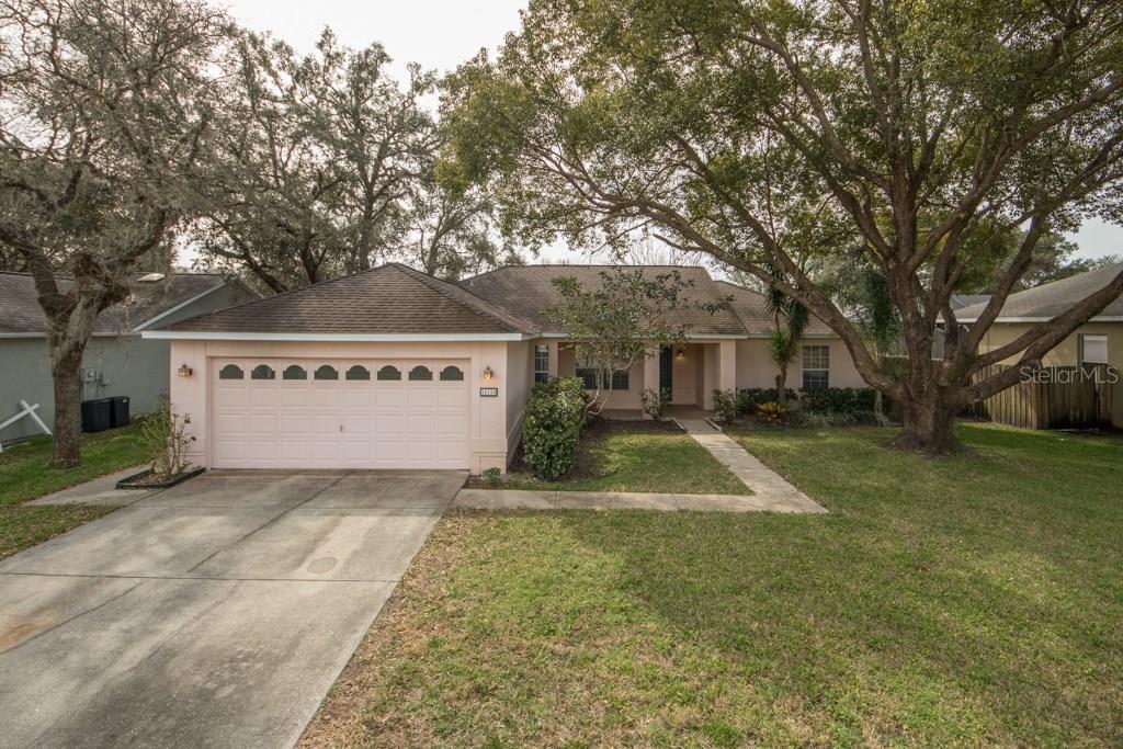 10120 Bozeman Drive New Port Richey, FL 34655 - Photo 1 of 1 a view of a white house with a yard and large tree