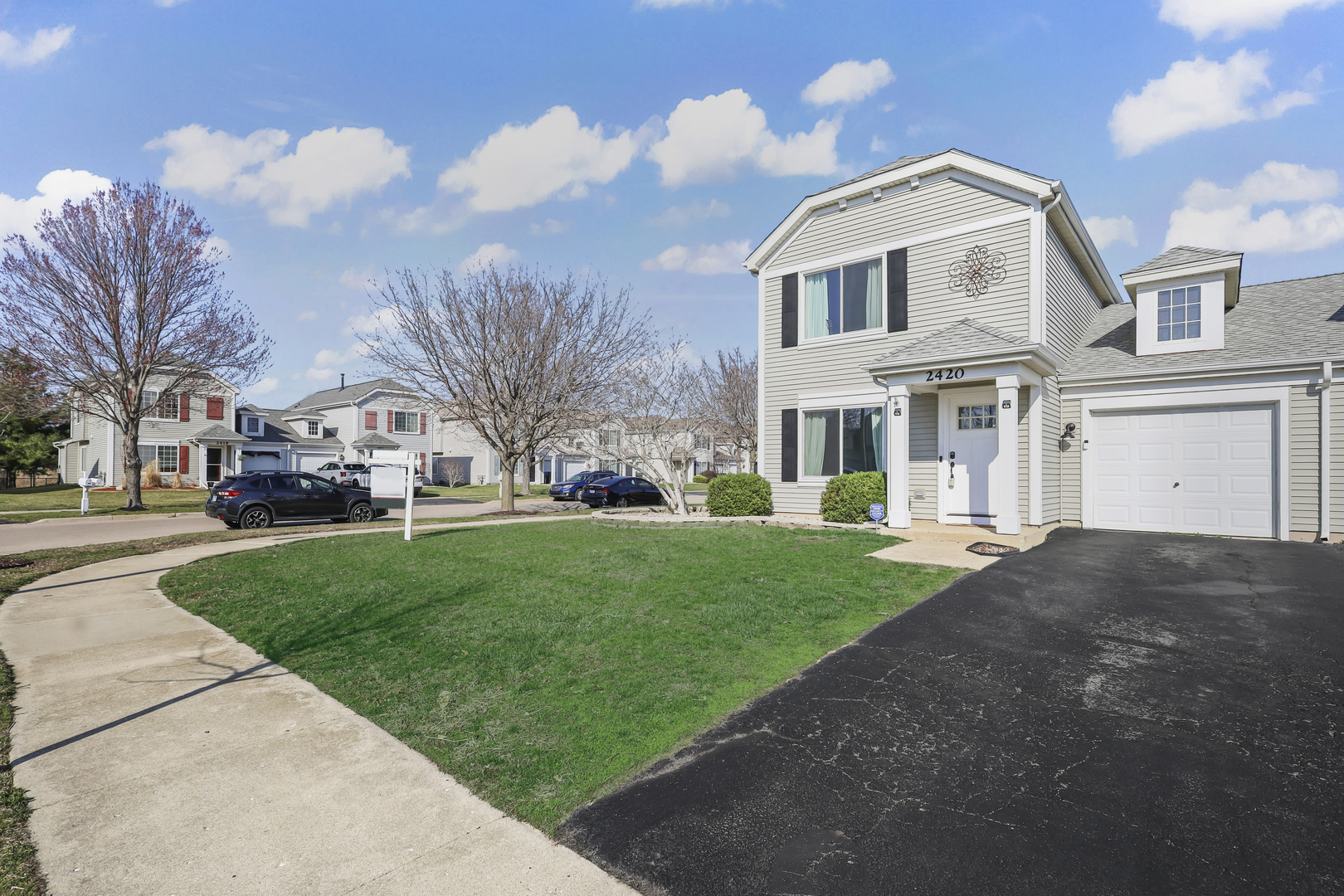 2420 Roxbury Lane Montgomery, IL 60538 - Photo 3 of 25 a front view of a house with a yard and garage
