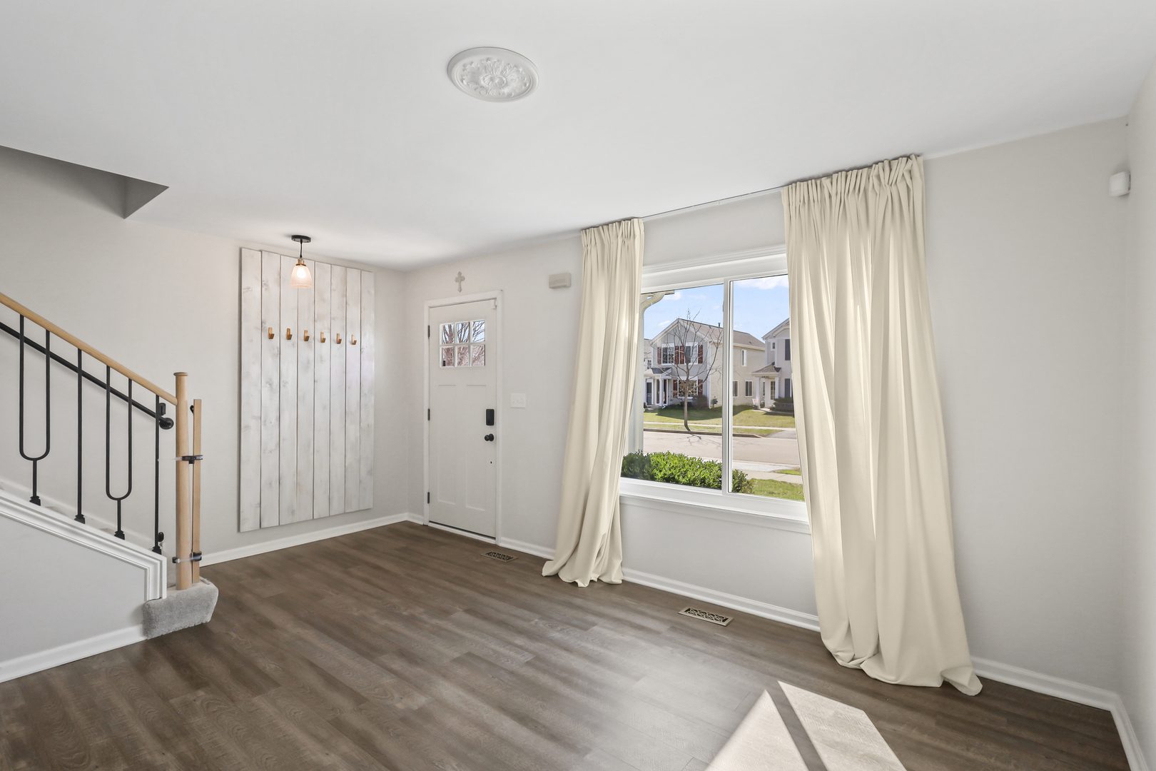 2420 Roxbury Lane Montgomery, IL 60538 - Photo 5 of 25 a view of an empty room with wooden floor and a window
