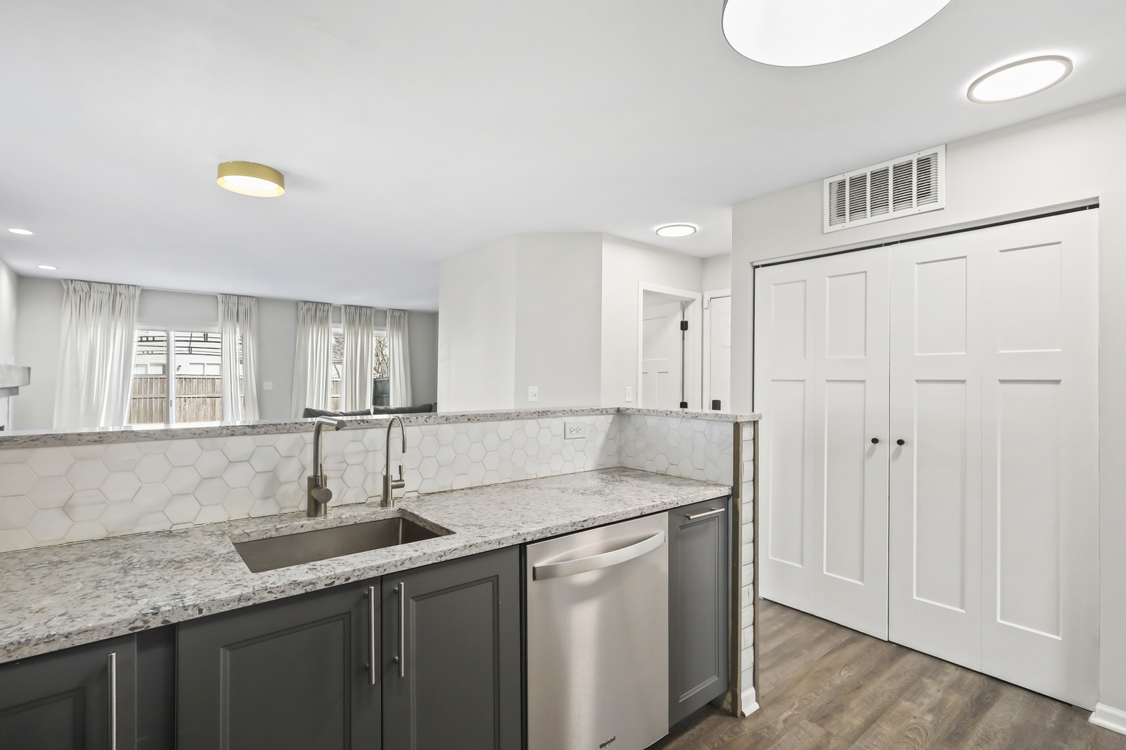 2420 Roxbury Lane Montgomery, IL 60538 - Photo 8 of 25 a kitchen with stainless steel appliances granite countertop a sink and dishwasher with wooden floor