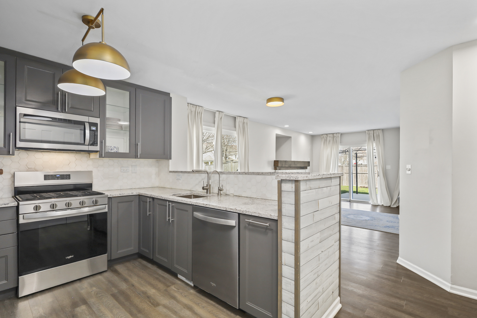 2420 Roxbury Lane Montgomery, IL 60538 - Photo 9 of 25 a kitchen with stainless steel appliances granite countertop a stove and a sink
