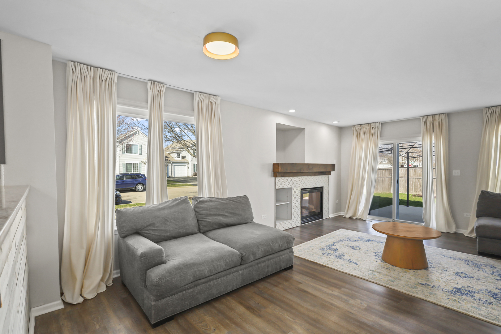 2420 Roxbury Lane Montgomery, IL 60538 - Photo 10 of 25 a living room with furniture a fireplace and a table