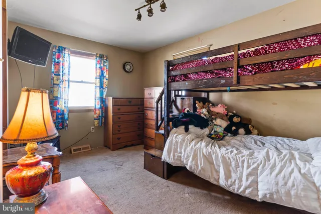 a living room filled with furniture and a baby crib