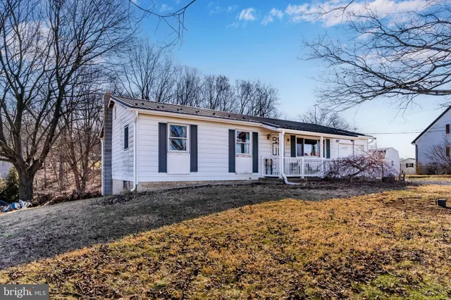 a view of a house with a yard covered with snow