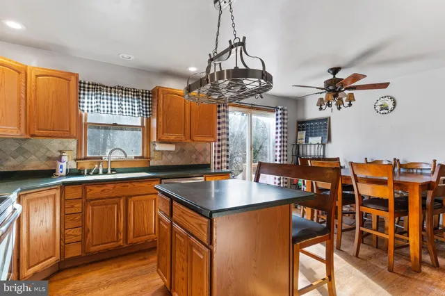 a kitchen with stainless steel appliances granite countertop a sink a stove and a refrigerator