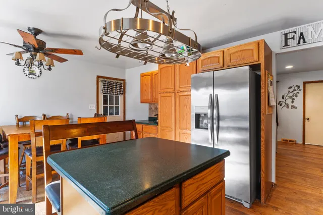 a kitchen with stainless steel appliances granite countertop a sink dishwasher and refrigerator