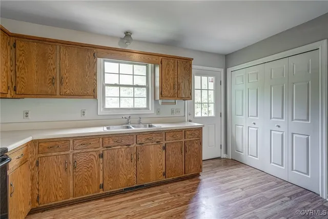 a spacious bathroom with a double vanity sink a mirror and a bathtub
